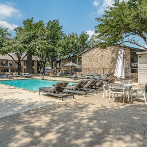 a pool with chairs and umbrellas