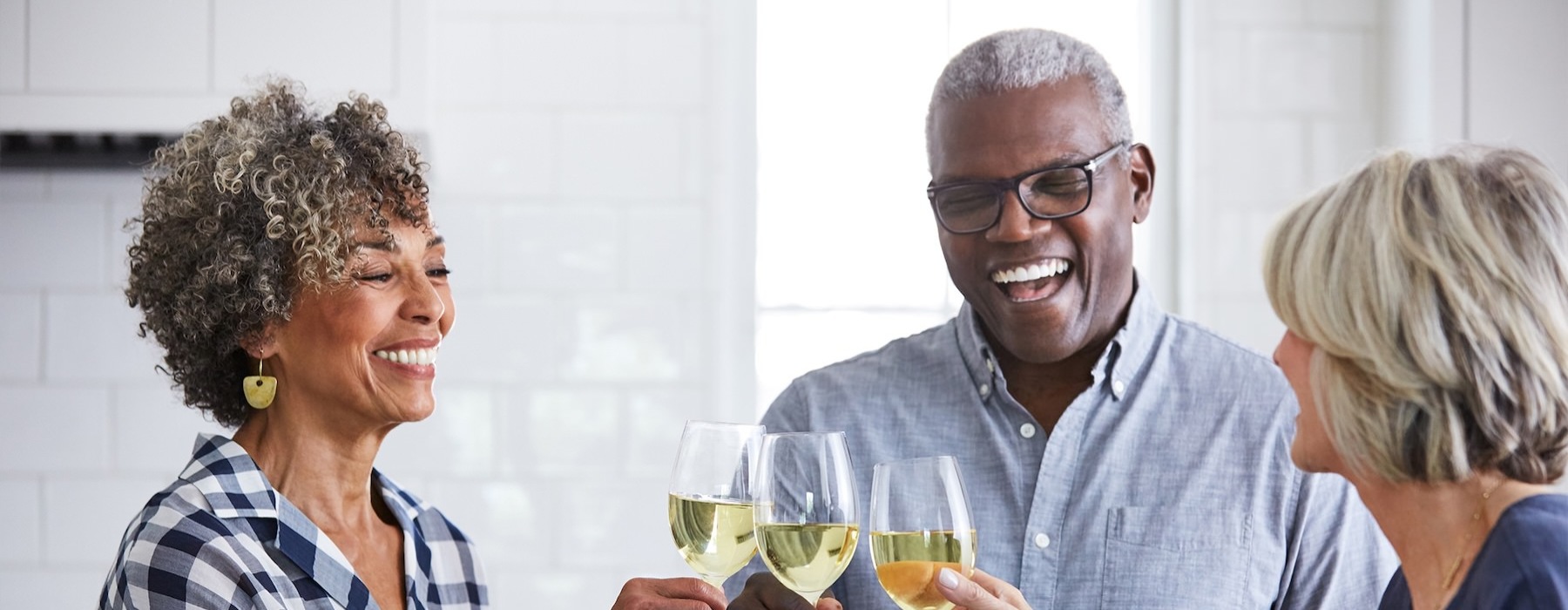 a few people toasting wine glasses