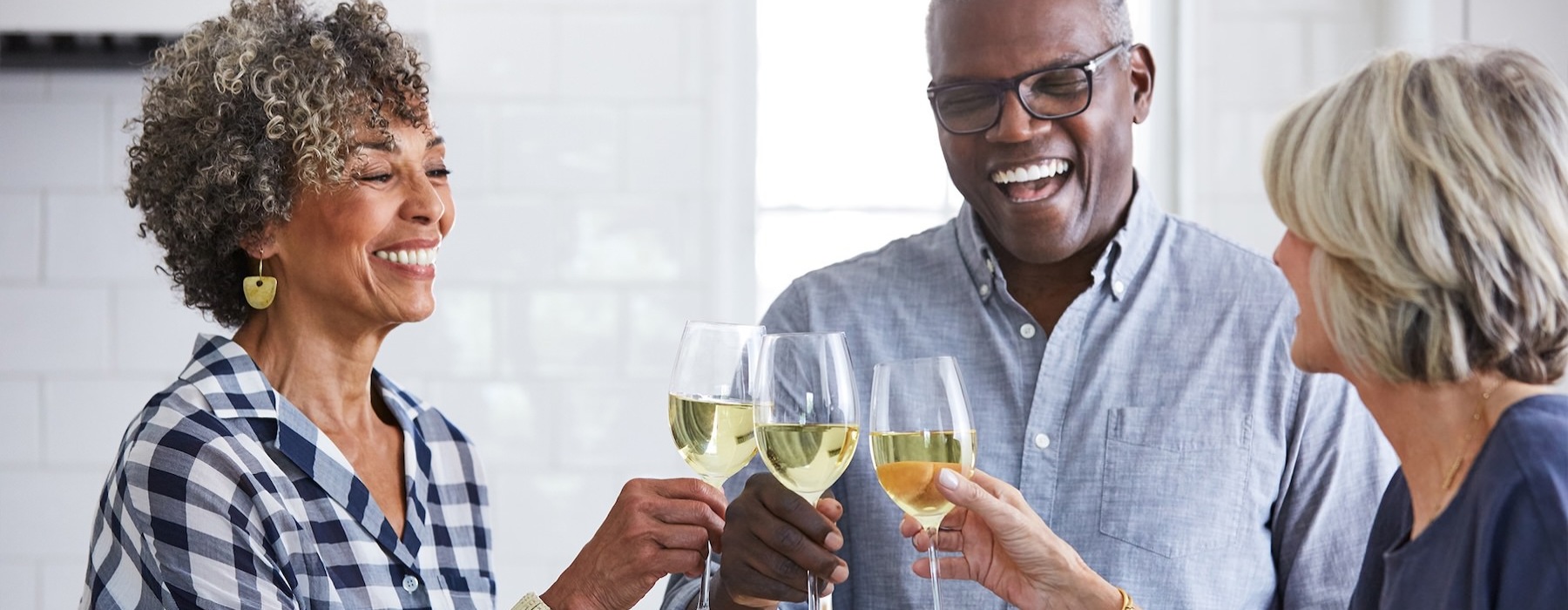 a few people toasting wine glasses